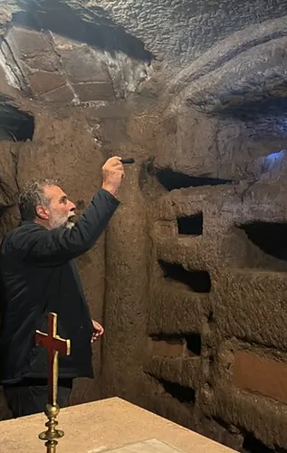 Exploring the underground corridors of the Roman catacombs.